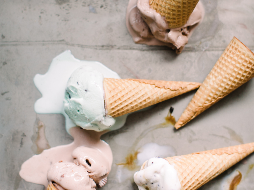 different flavors of ice cream in ice cream cones on the ground