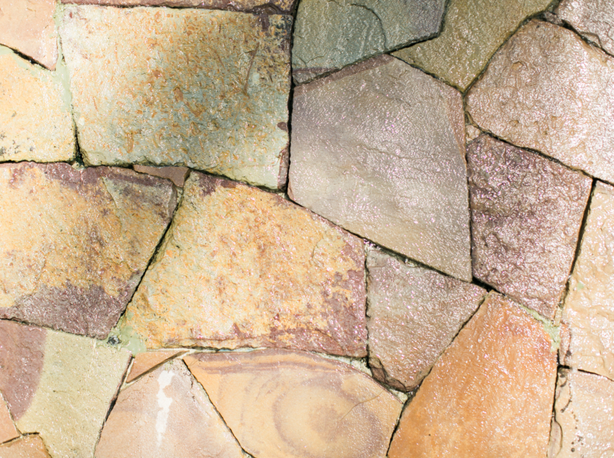 In the image we can see a portion of the wall or floor decorated with softly colored flagstones in gradient.