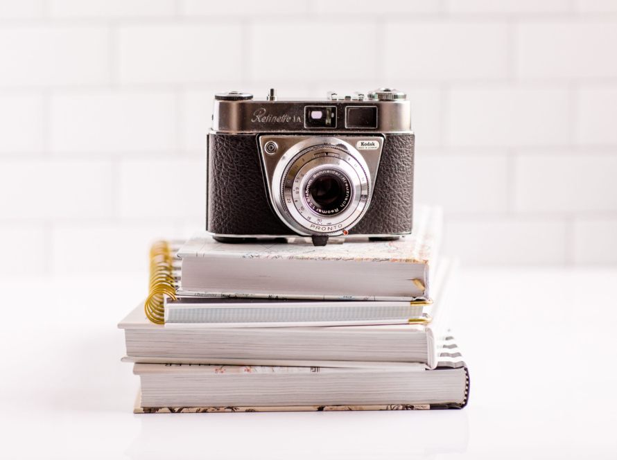 In the image, we can see a camera resting on three books.