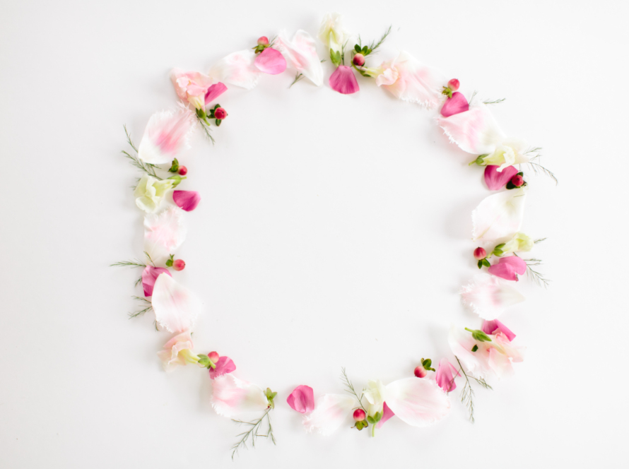 In the image, we can see a circle of delicate flowers on a white background.